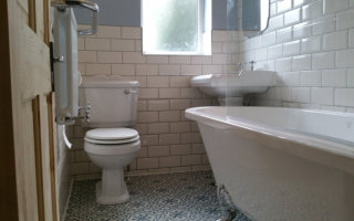 Victorian bathroom with free standing bath and white metro tiles