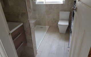 Hotel style bathroom with walk in shower and wall mounted vanity unit